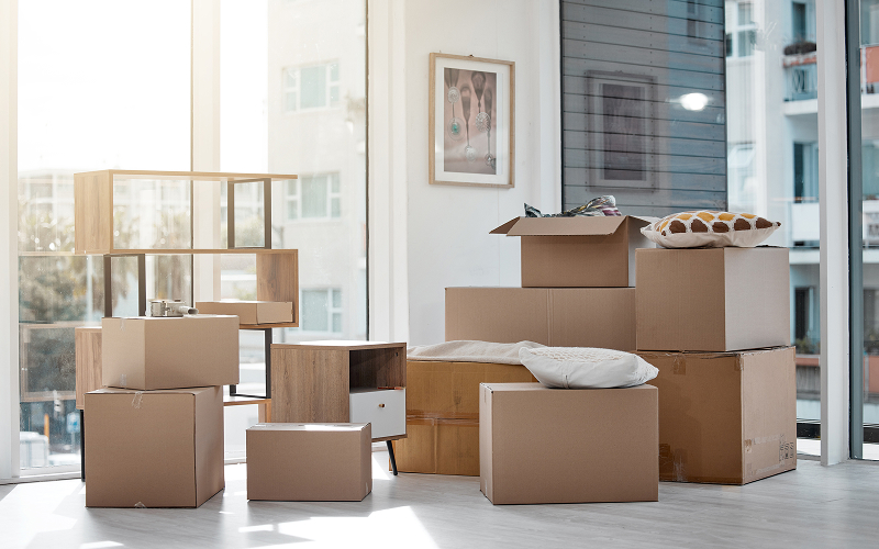 Packed moving boxes and furniture in a Singapore condo unit.