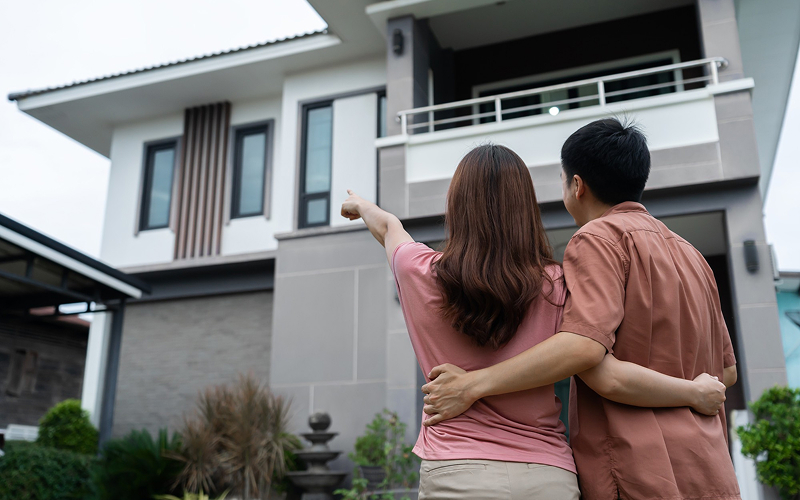 Couple looking at a landed house for pre-move site visit.