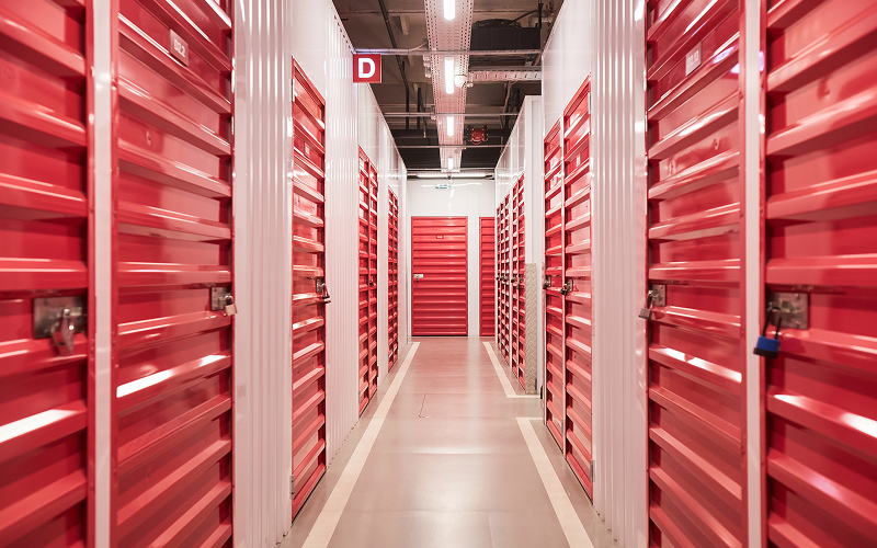 Row of red temporary storage units for a household move.